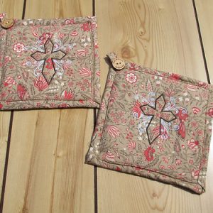 Old rugged cross embroidered potholders
